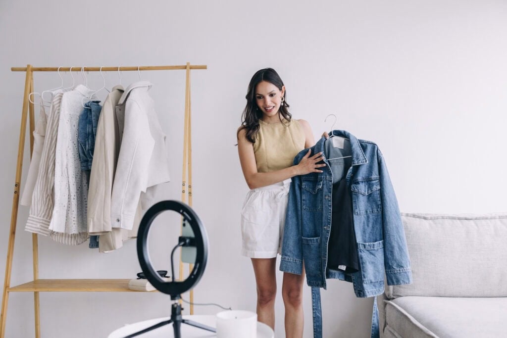 person holding clothing and filming